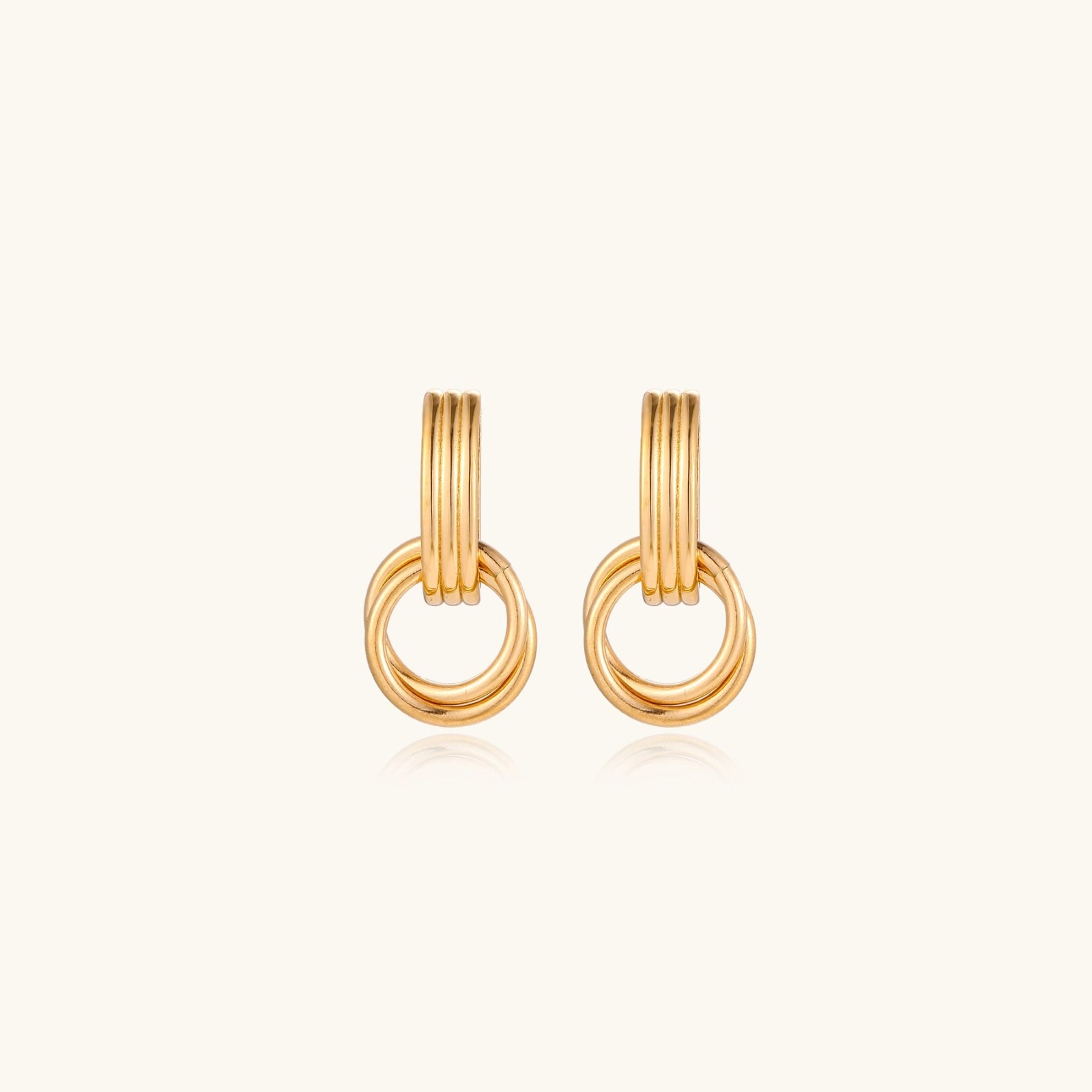 Triple ring gold-tone drop earrings close-up
