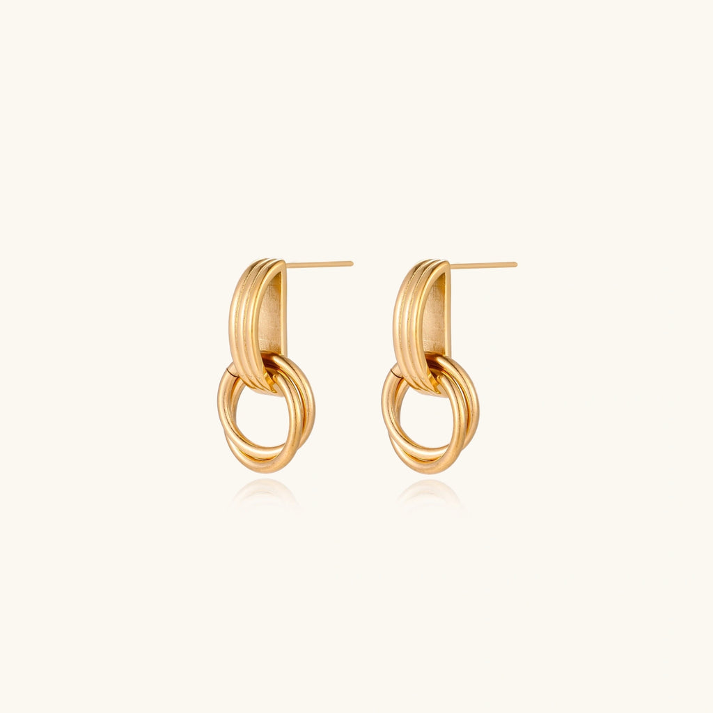 Architectural gold-tone drop earrings detail
