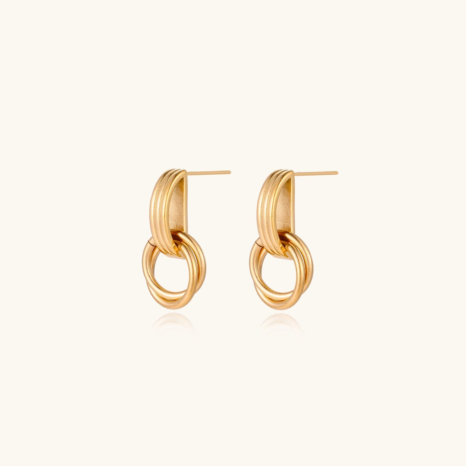 Architectural gold-tone drop earrings detail