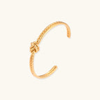 Rope-textured gold-tone knot cuff close-up