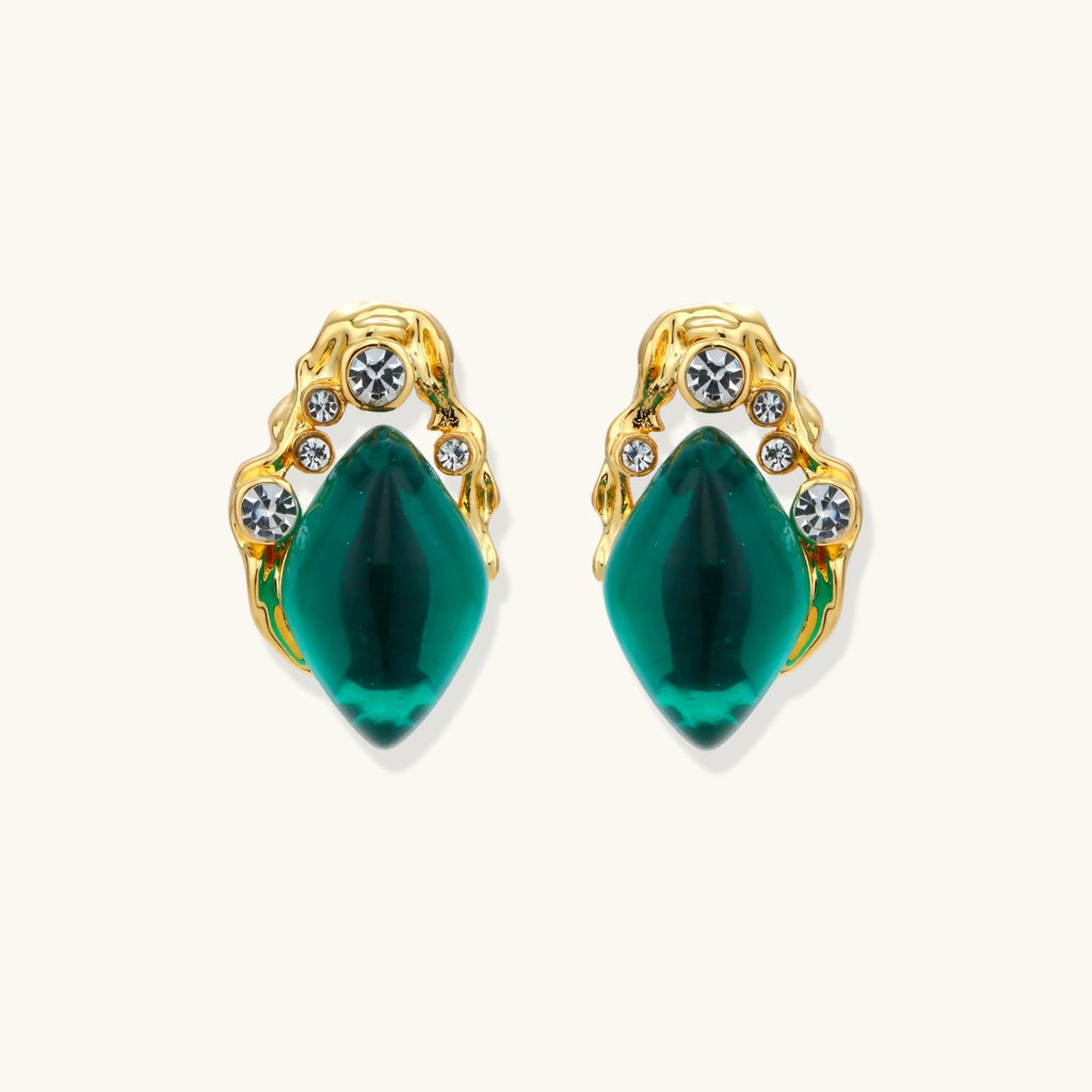 Emerald green gold-tone studs close-up