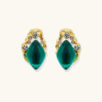 Emerald green gold-tone studs close-up