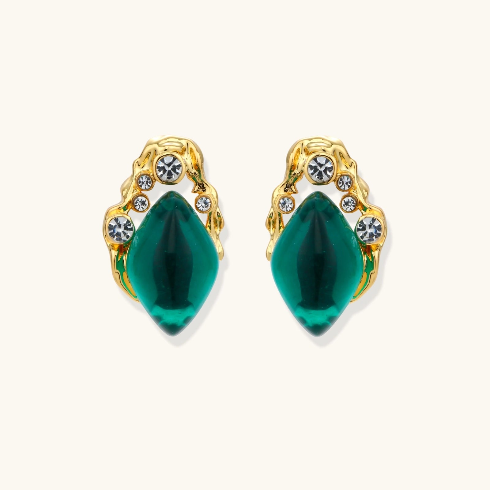 Emerald green gold-tone studs close-up