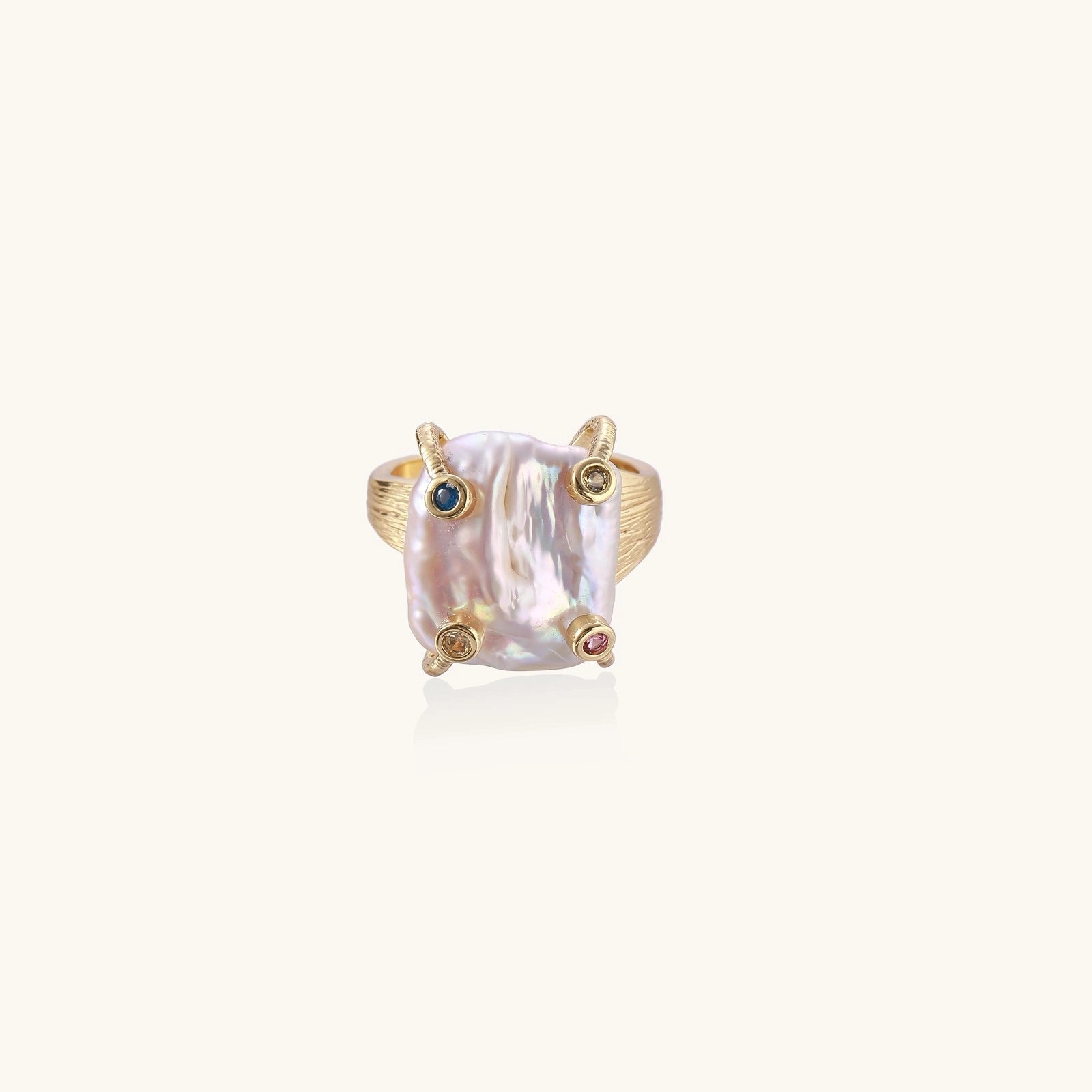 Gold-tone pearl ring with gemstone accents close-up