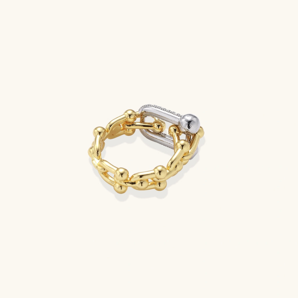Gold-tone stacked-look ring on cream background