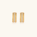 Textured gold-tone hoop earrings close-up