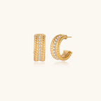 Chunky textured gold-tone hoop earrings on cream background