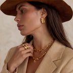Gold-tone wave hoops shown as a pair