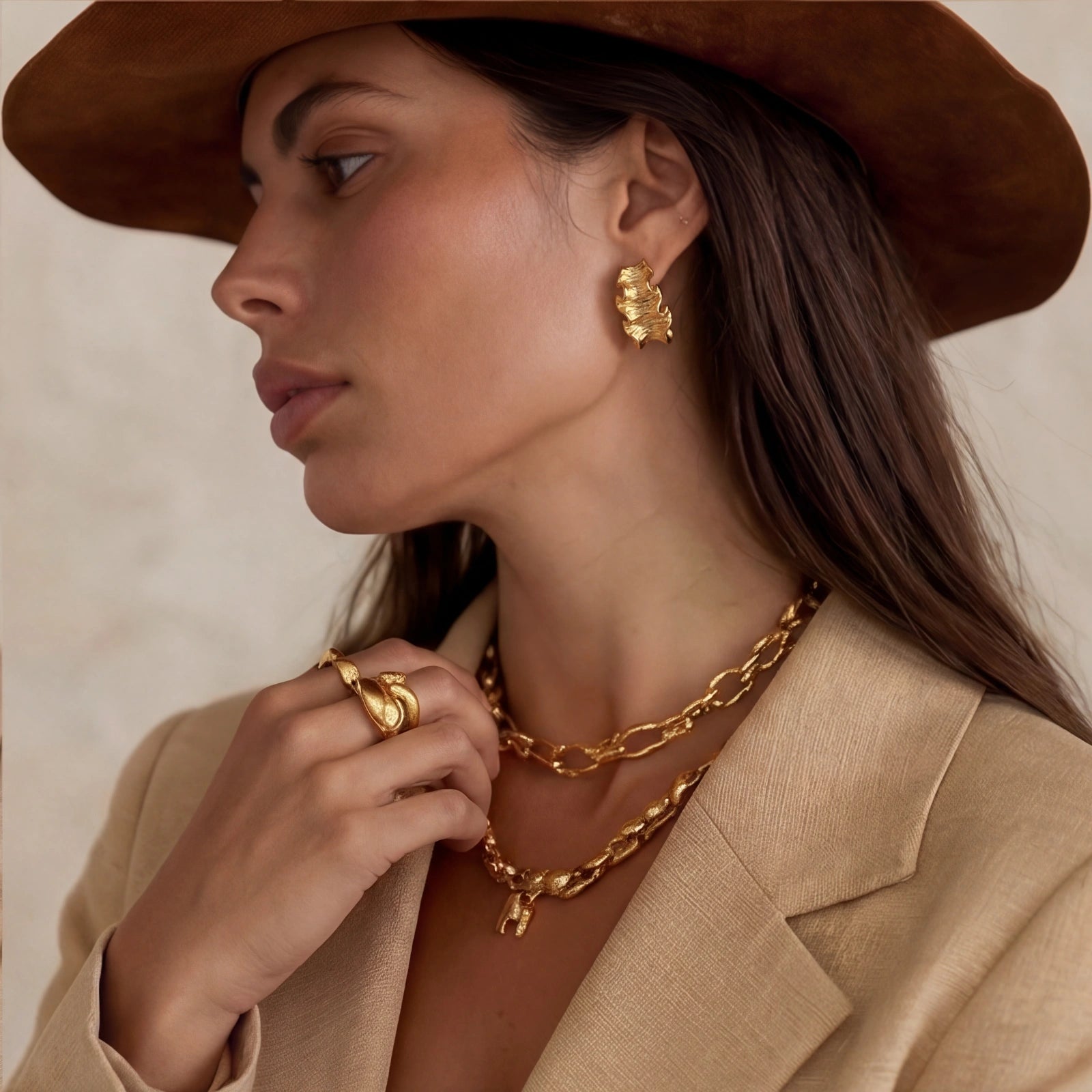 Gold-tone wave hoops shown as a pair