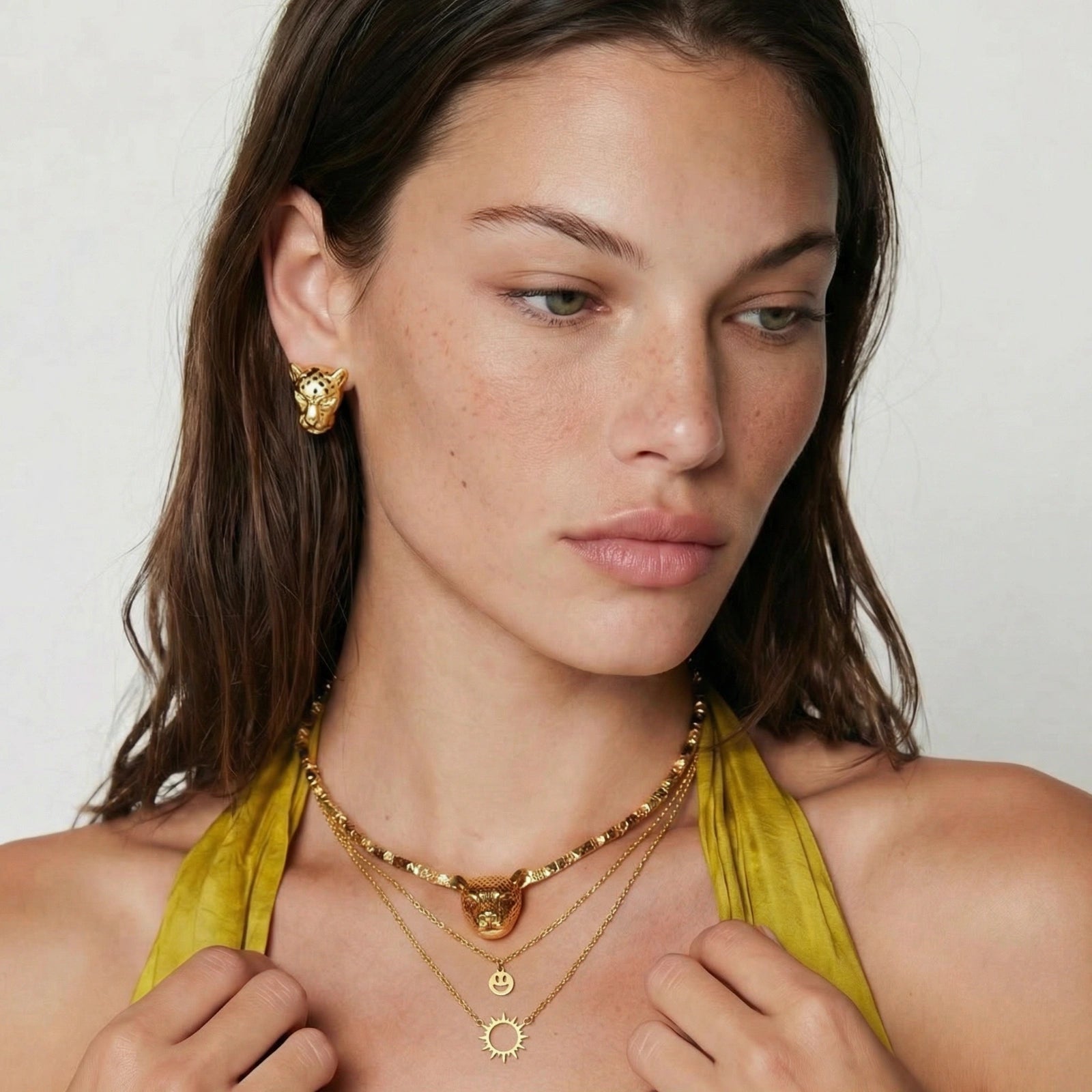Sun and smiley necklace shown on model