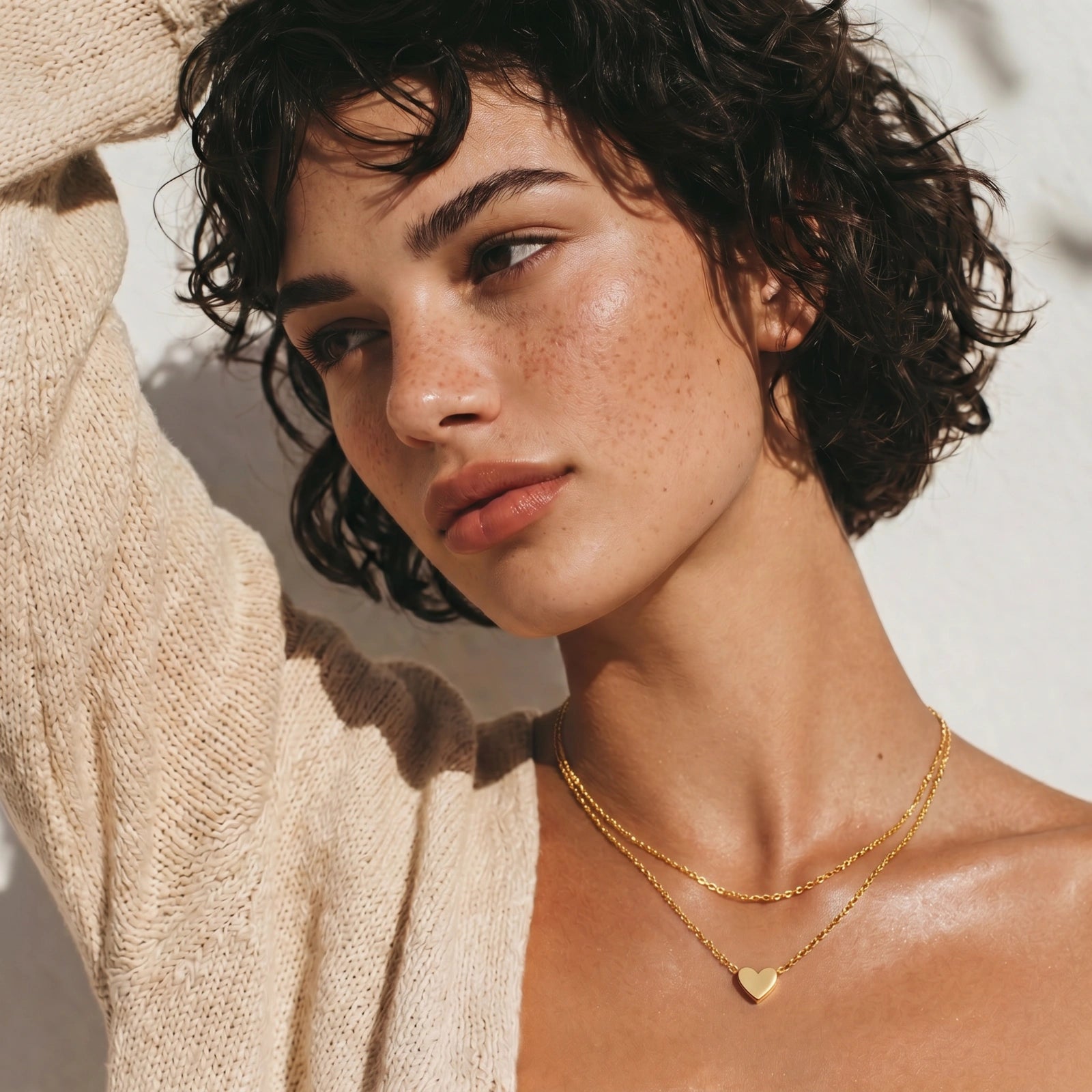 Gold-tone layered heart necklace shown on model