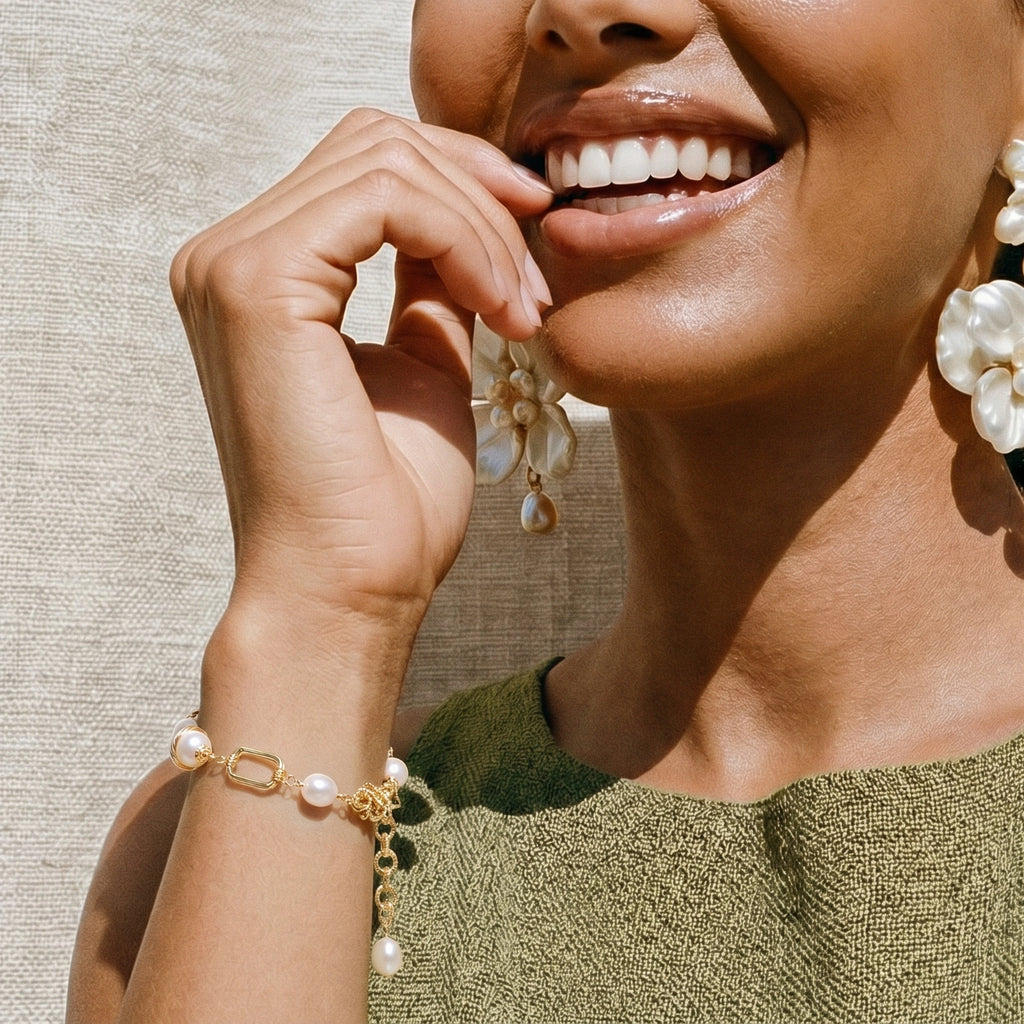 Gold-tone pearl bracelet on white background