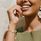 Gold-tone pearl bracelet on white background