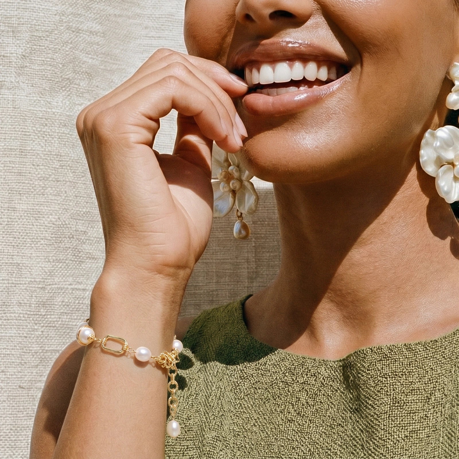 Gold-tone pearl bracelet on white background