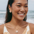Enamel peony studs on white background