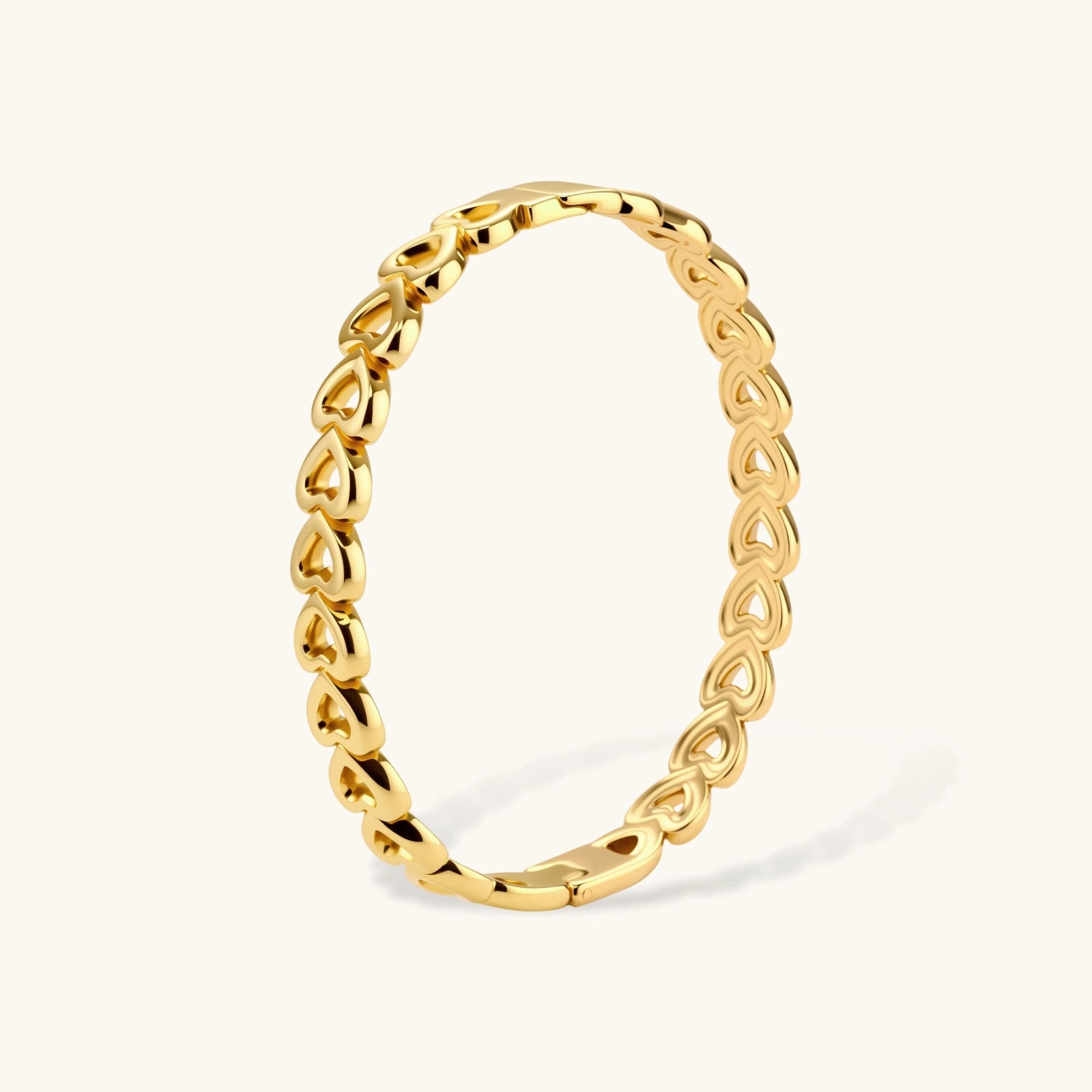 Heart-link gold-tone bangle close-up