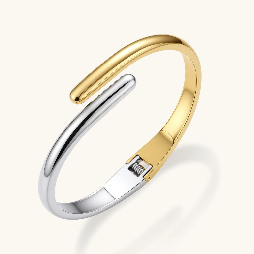 Gold and silver-tone bypass cuff close-up
