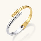 Gold and silver-tone bypass cuff close-up