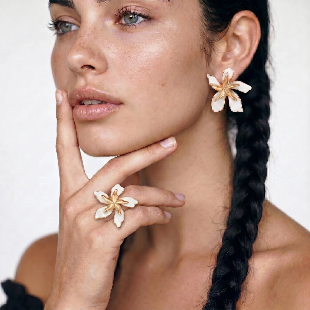 White enamel statement earrings on cream background