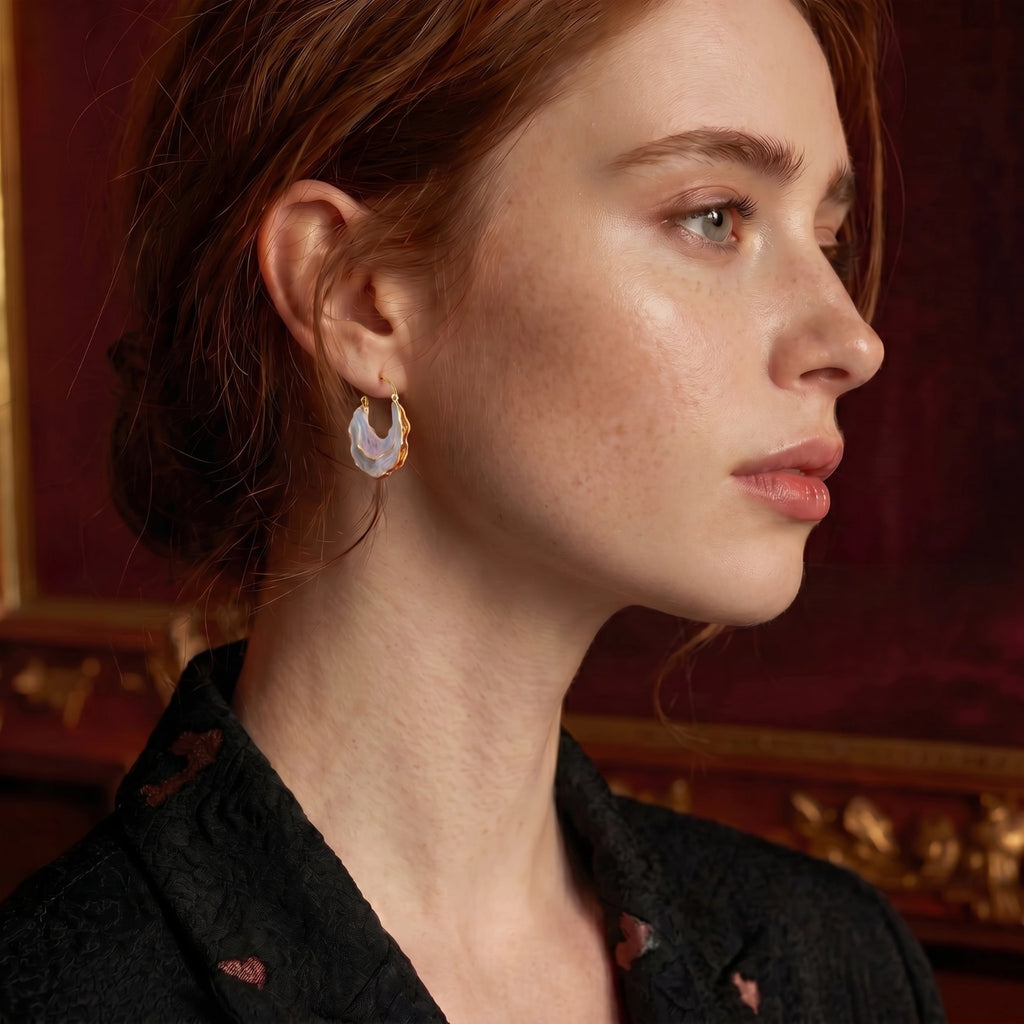 Iridescent gold-tone shell hoops styled view