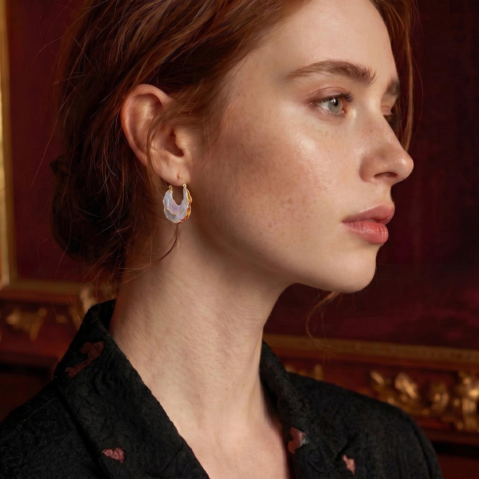 Iridescent gold-tone shell hoops styled view