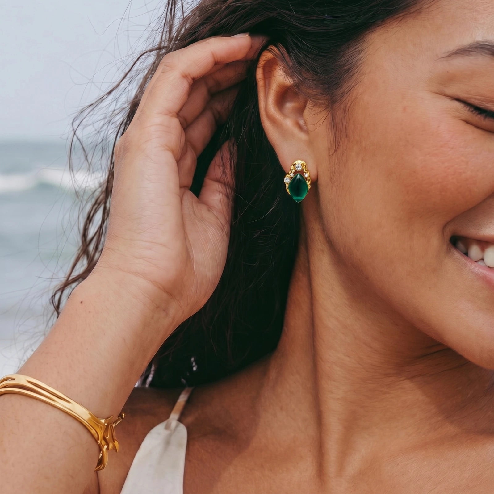 Emerald green gold-tone stud earrings styled