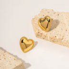 Heart earrings styled with a stack