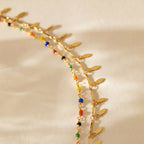 Gold-tone anklet on white background