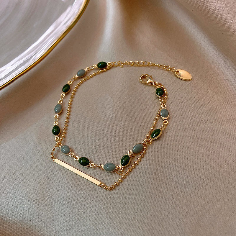 Gold-tone chain bracelet on white background