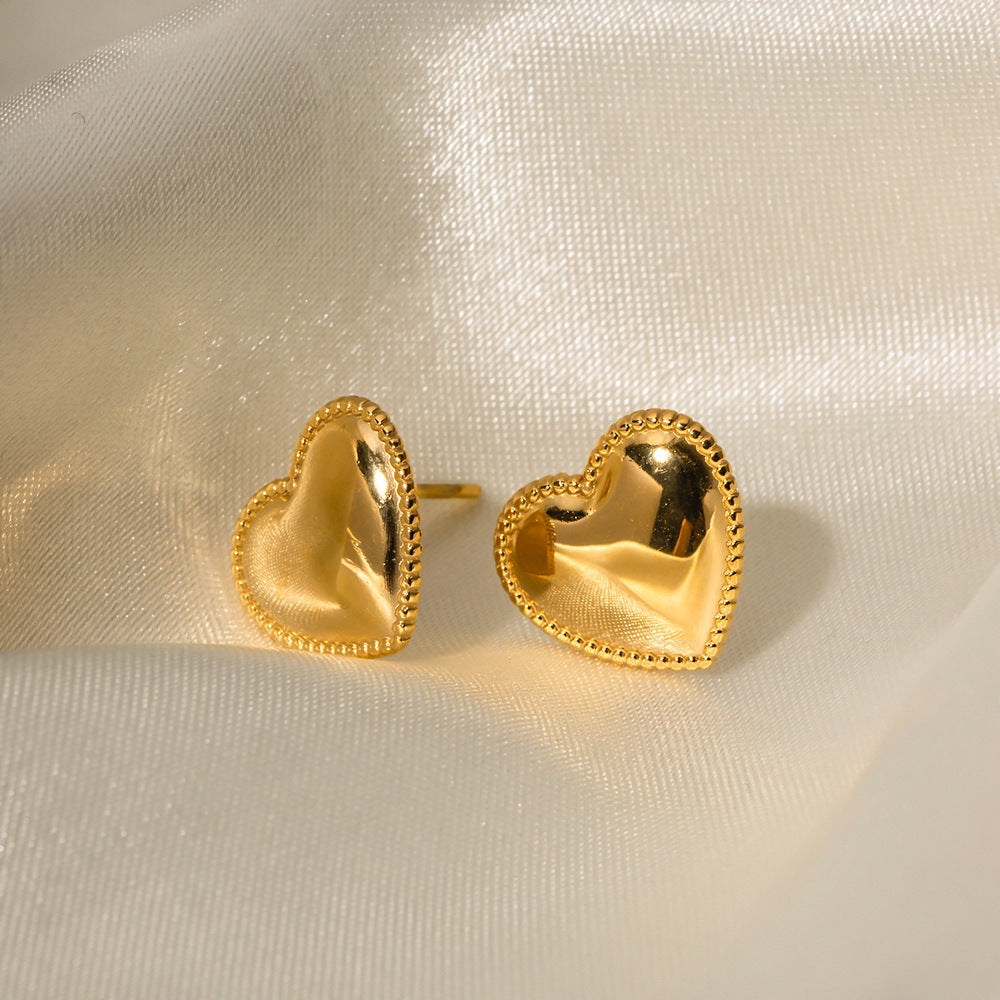 Heart studs held in hand