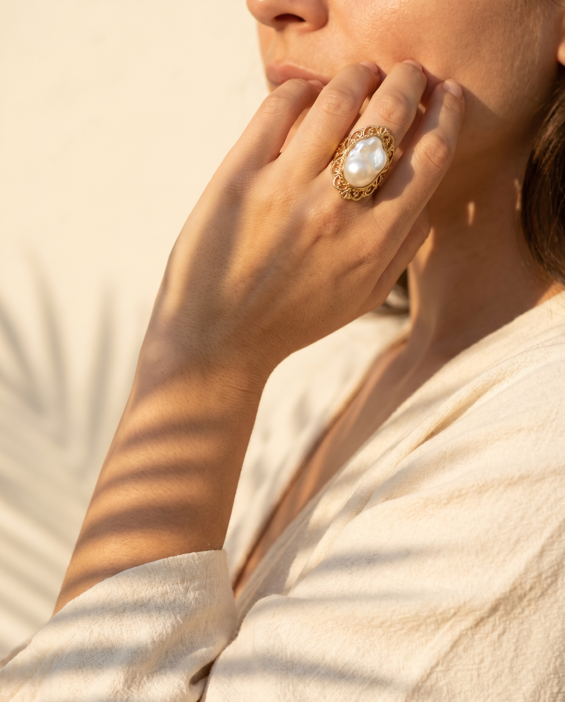Baroque pearl crown ring shown on model