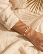 Layered pearl bracelet shown on model
