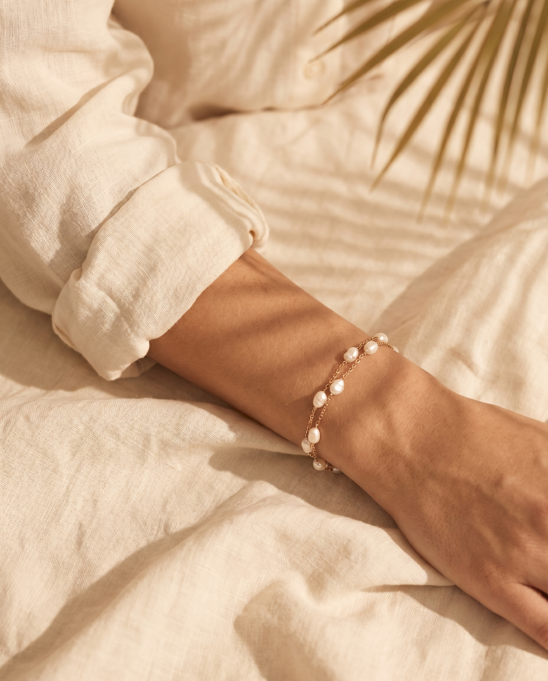 Layered pearl bracelet shown on model